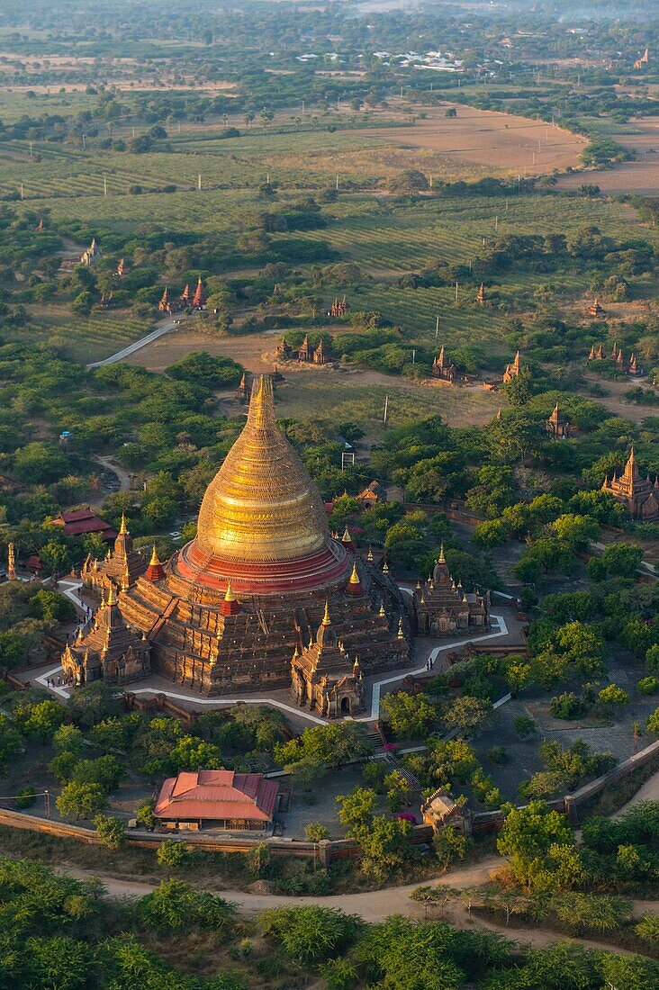 View of the Dhammayazika Pagoda from a hot air balloon flying over Bagan, Myanmar in the early morning.