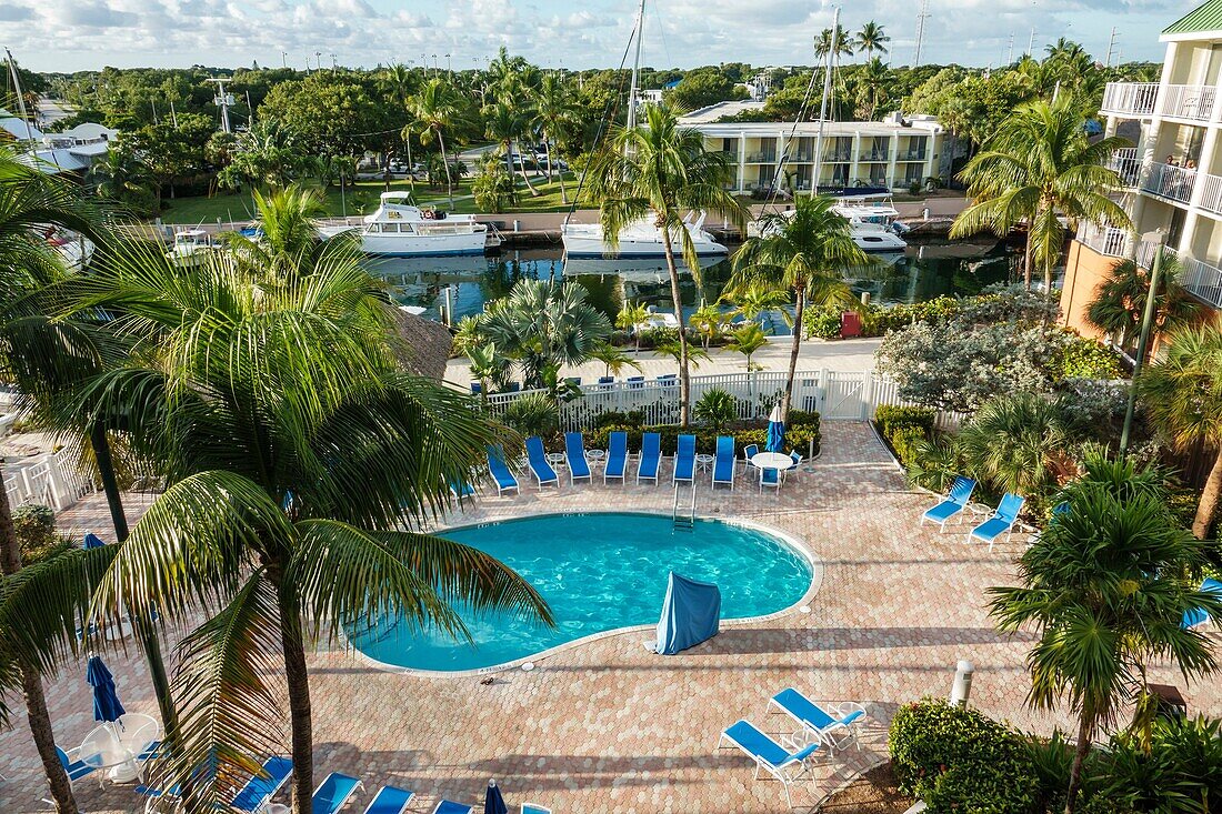 Florida, Key Largo, Upper Florida Keys, Courtyard Key Largo, hotel, waterfront, pool, lounge chair, canal, boats, swimming pool