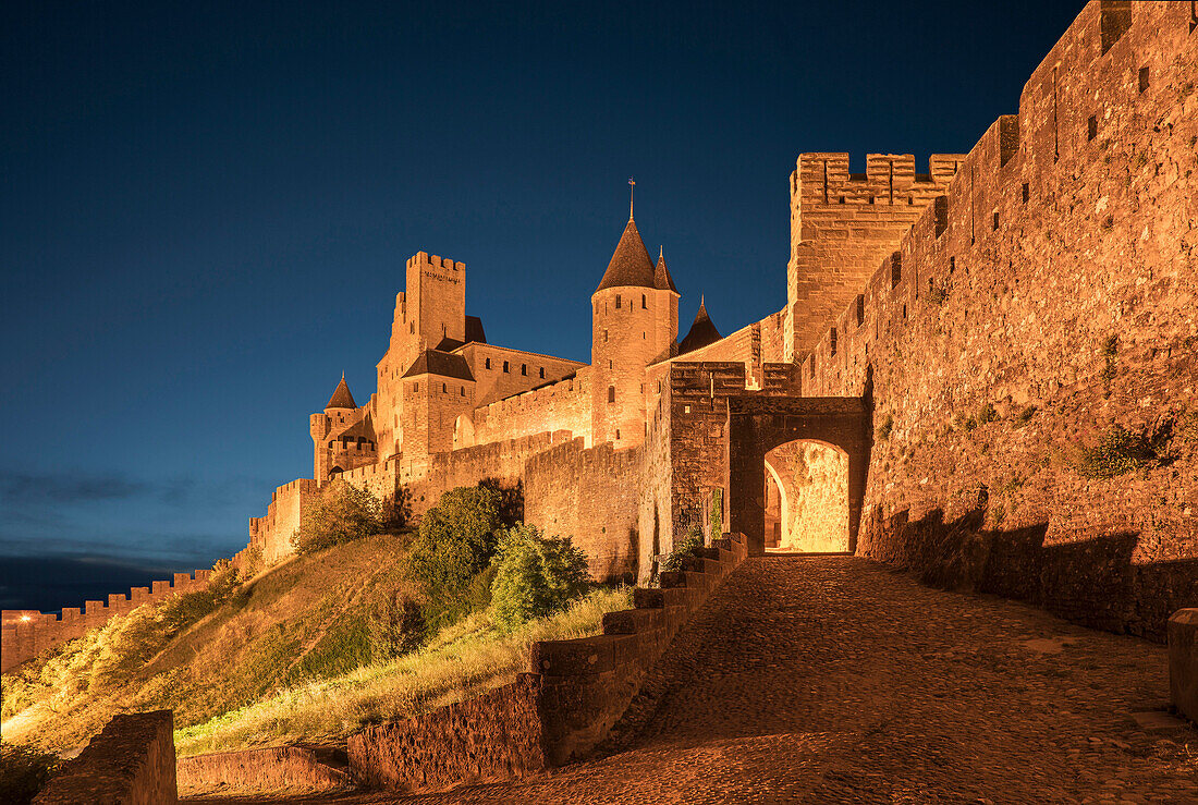 Road to castle at night in Carcassonne, Languedoc-Roussillon, France