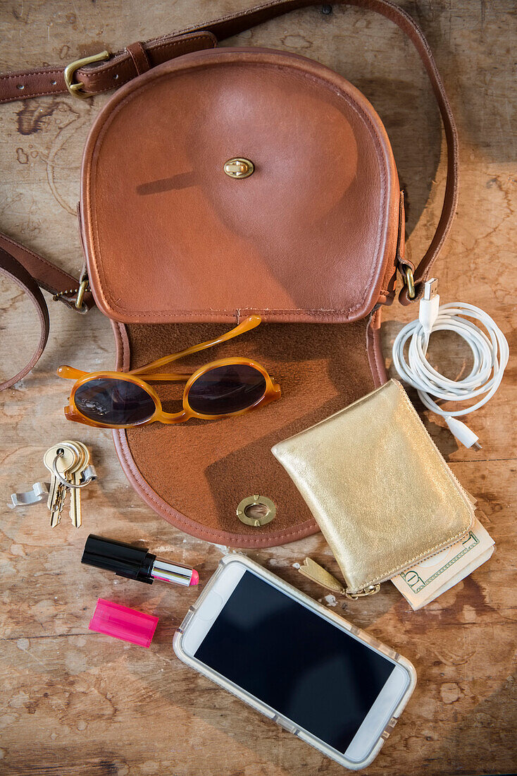 Purse with wall, cell phone, lipstick and sunglasses