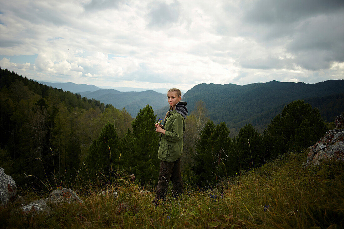 Portrait of Caucasian girl standing on mountain range