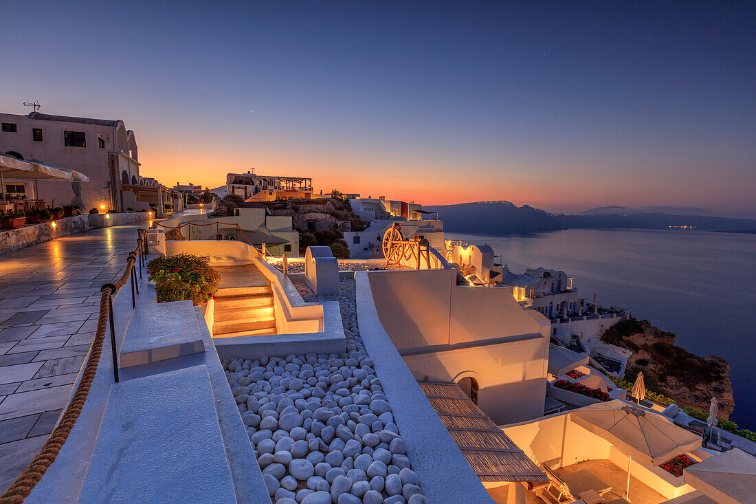 The dusk lights illuminate the typical greek village of Oia Santorini Cyclades South Aegean Greece Europe
