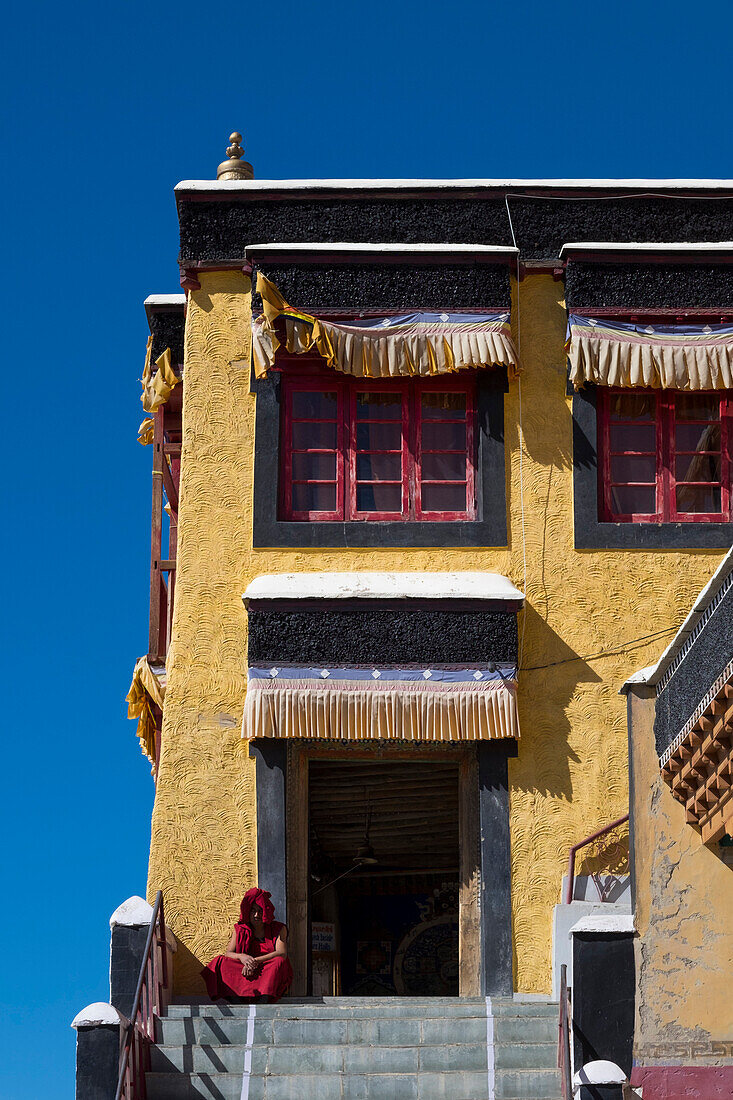 Thiksey Monastery, Indus Valley, Ladakh, India, Asia, Buddhist monk in front of central temple entrance