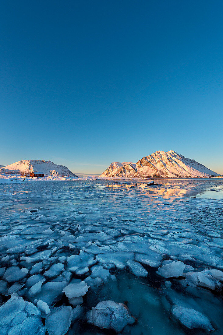 Lofoten Islands, Norway A bay with icy mountains in the background and a rorbu January 2015