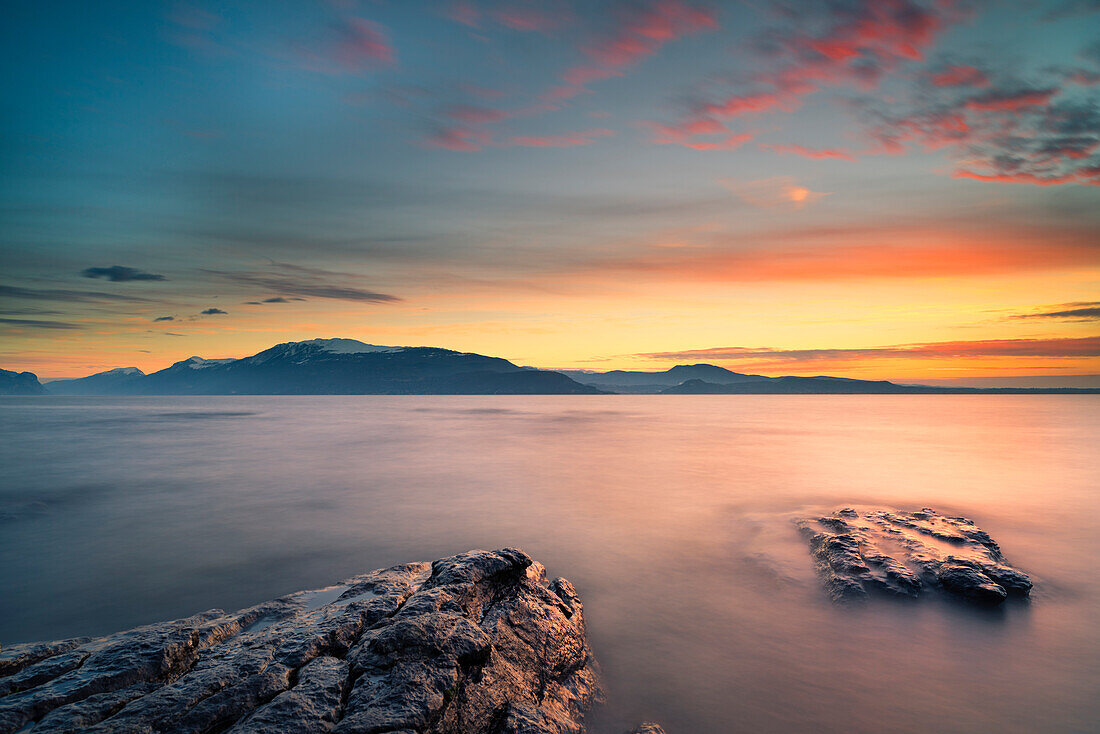 Manerba, Garda Lake, Brescia, Italy Sunrise on Lake Garda, in the locality Manerba, in front of Mount Baldo