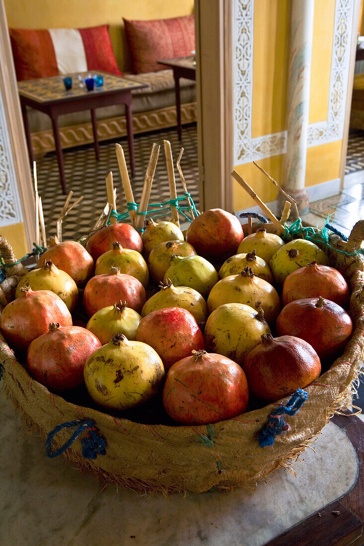 Morocco, Tangier, basket full of pomegranates in the hall of the Hotel Nord Pinus
