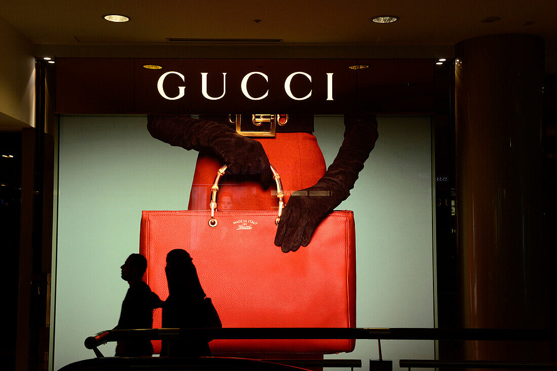 South-East Asia, Malaysia, Kuala Lumpur, a mall, couple walking in front the Gucci store