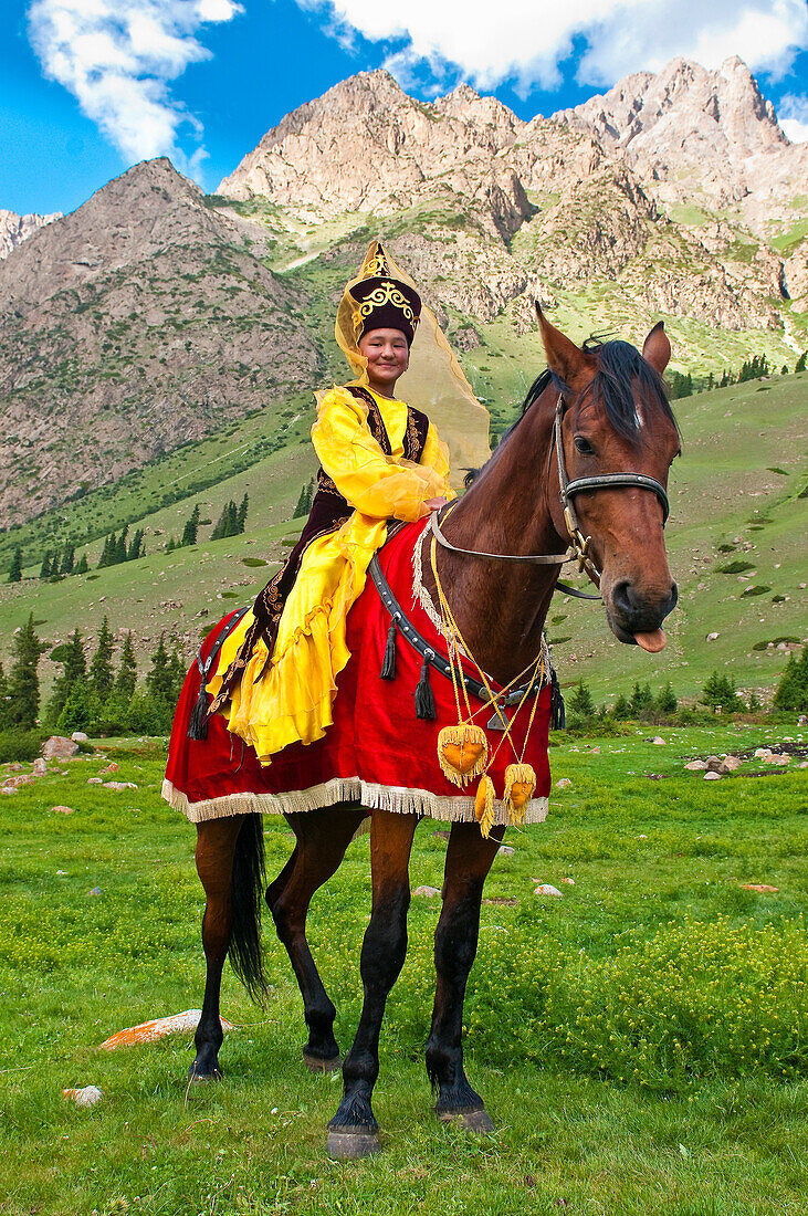 Kyrgyzstan, Issyk Kul Province (Ysyk-Kol), Juuku valley, Goulzana Talantbekoze wears the traditional Kiz Kumai clothes, a horse game where the man tries to catch a girl on horseback and kiss her