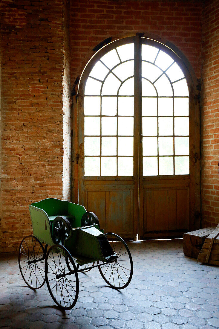 France, Burgundy, Yonne. Saint Fargeau castle. Decorated room. Old children car