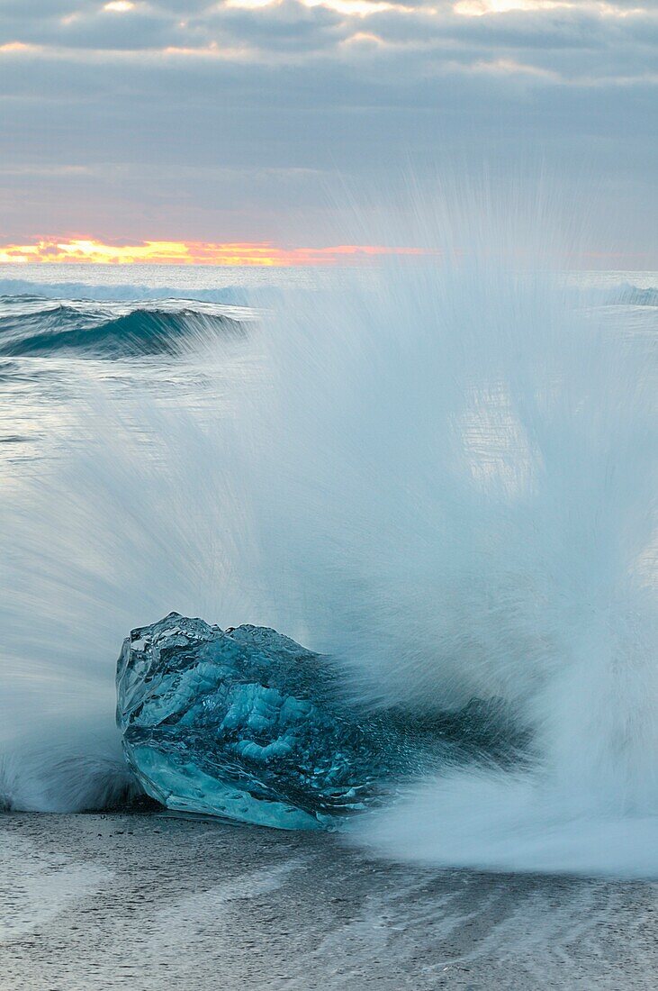 wave that breaks on ice on the beach of J?kuls?rl?n , Iceland