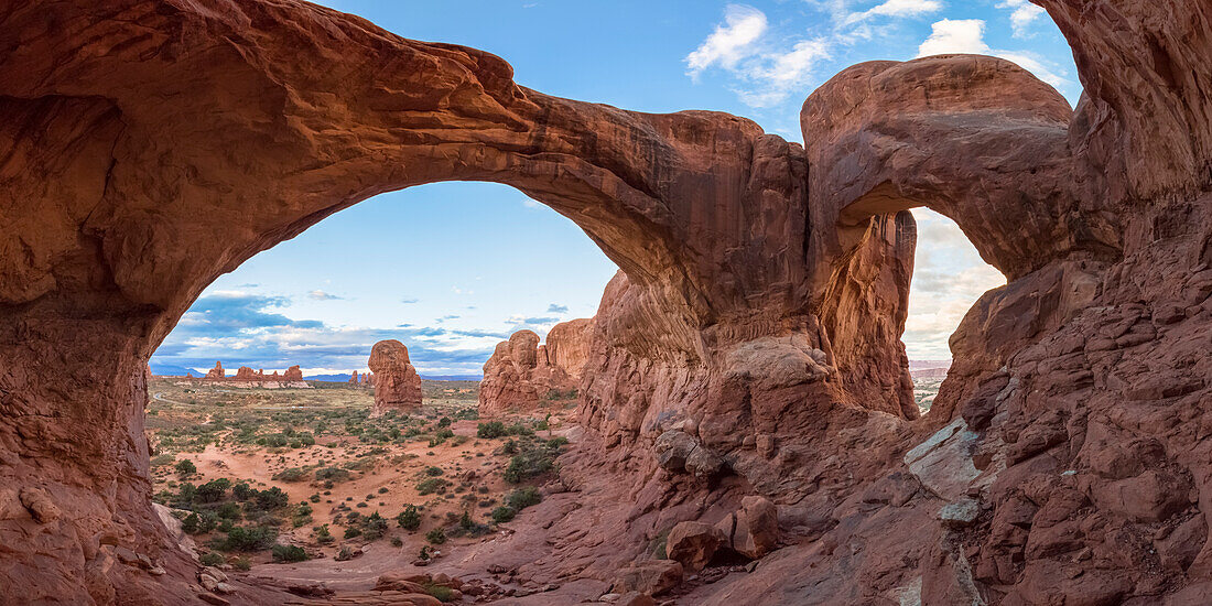 Person under Double Arch, Arches National Park, Moab, Grand County, Utah, USA