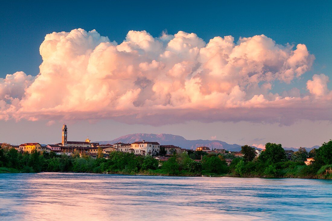 Urago d'Oglio, Po valley, Brescia, Italy, Sunset and big cloud on village
