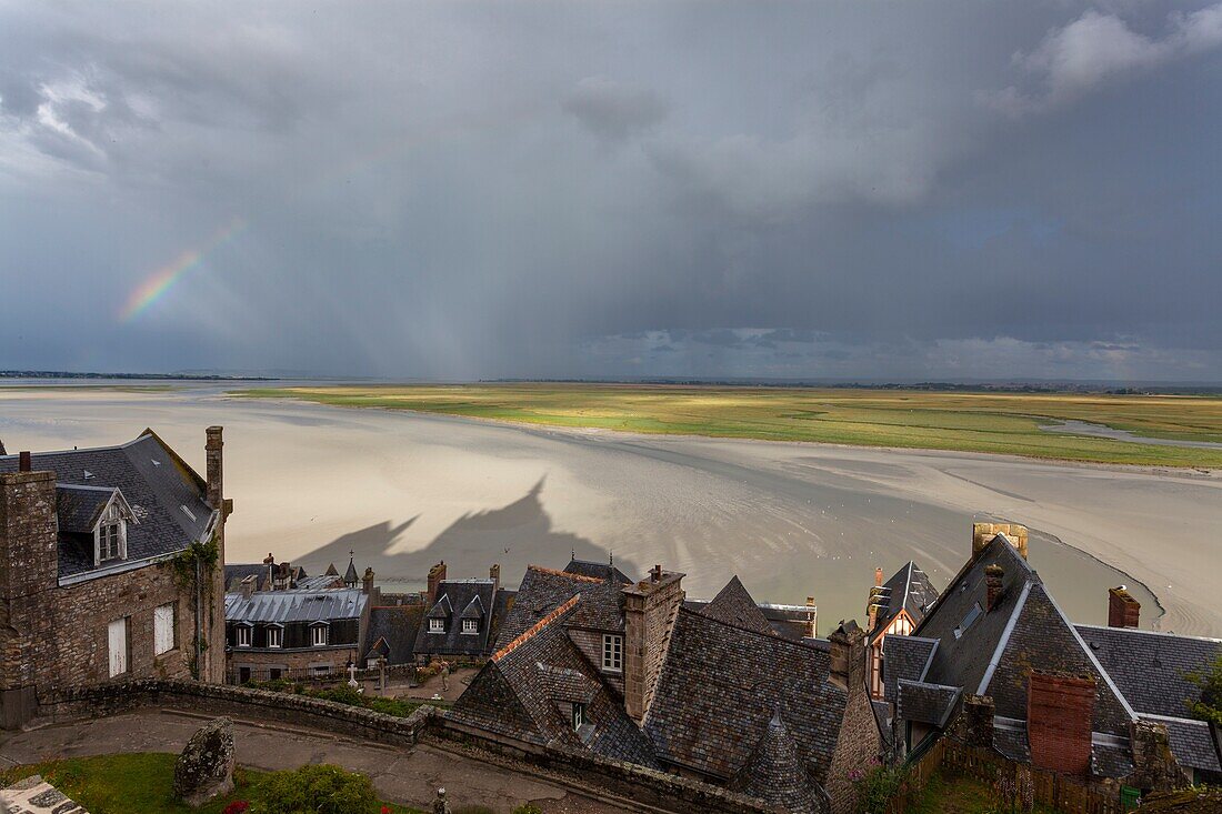 Mont Saint Michel, Normandy, France, A view of bay with rainbow and abbey's shadow