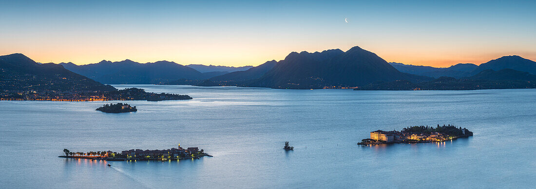 Borromean Islands, Stresa, Lake Maggiore, Verbano-Cusio-Ossola, Piedmont, Italy, Panoramic view over the isles at dawn with moon