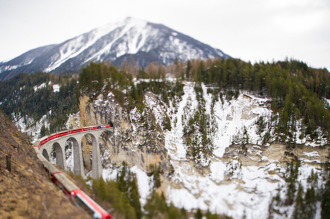 Red Bernina Express train and the Landwasser viaduct, Engadine, Switzerland, Europe