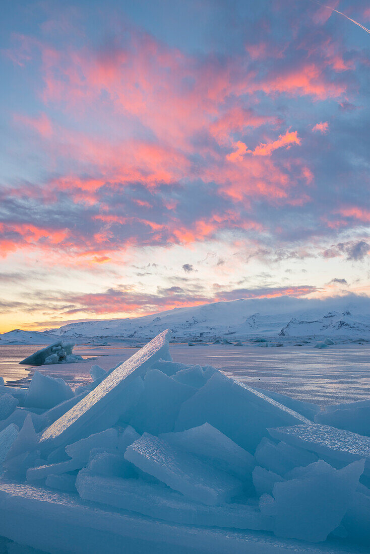 Jokulsarlon glacier lagoon, Iceland, Europe, Blocks of ice in the frozen lagoon on a winter sunset