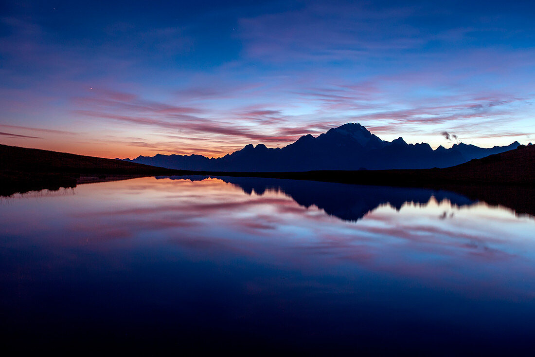 Blue hours at Campagneda lake, in the background Disgrazia mountain, Malenco valley, Lombardy, Italy