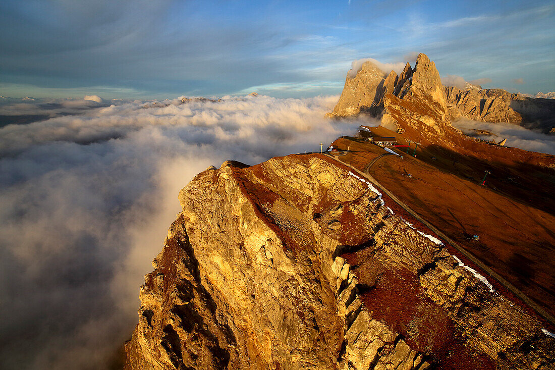 Aerial shot from Seceda of Odle surrounded by clouds at sunset, Dolomites Val Funes Trentino Alto Adige South Tyrol Italy Europe