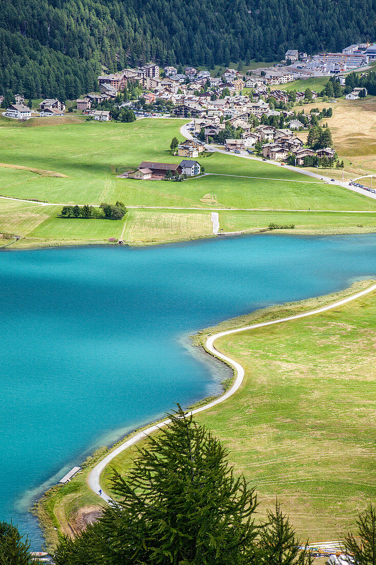 The turquoise water of Lake Silvaplana surrounded by green meadows Engadine Canton of Grisons Switzerland Europe