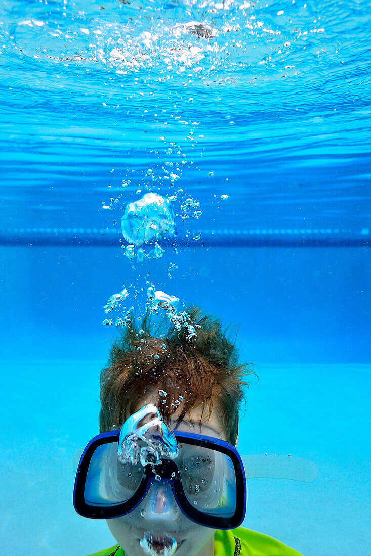 Underwater View Of A Boy Snorkeling In A Pool