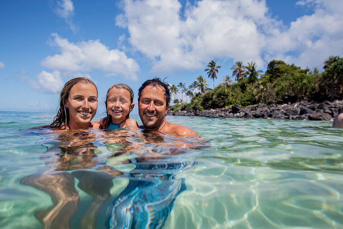 A Family Enjoying At Waimea Bay On The North Shore Of Oahu