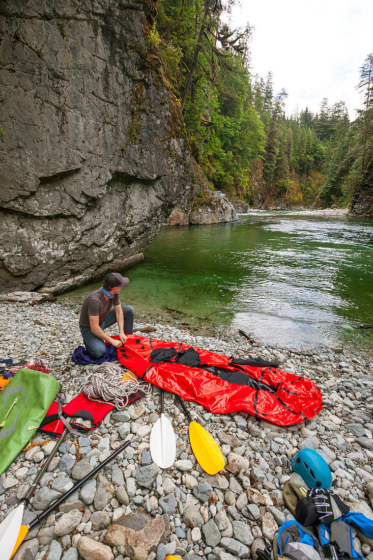 A Paddler Fills His Packraft With Air Before Packrafting The Chehalis River