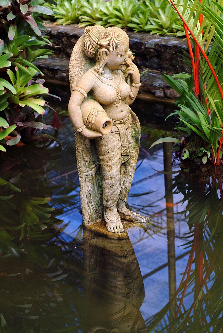 Thai Statue Of A Female Goddess In A Garden Koi Pond, Nong Nooch, Thailand
