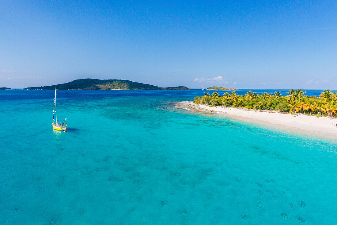 A Sailboat Moored Off An Uninhabited Islet Of The British Virgin Islands In The Caribbean