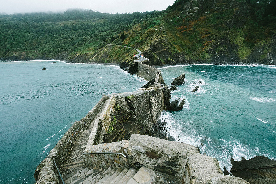 View Of The Islet Of Gaztelugatxe Connected To The Mainland By A Man-made Bridge