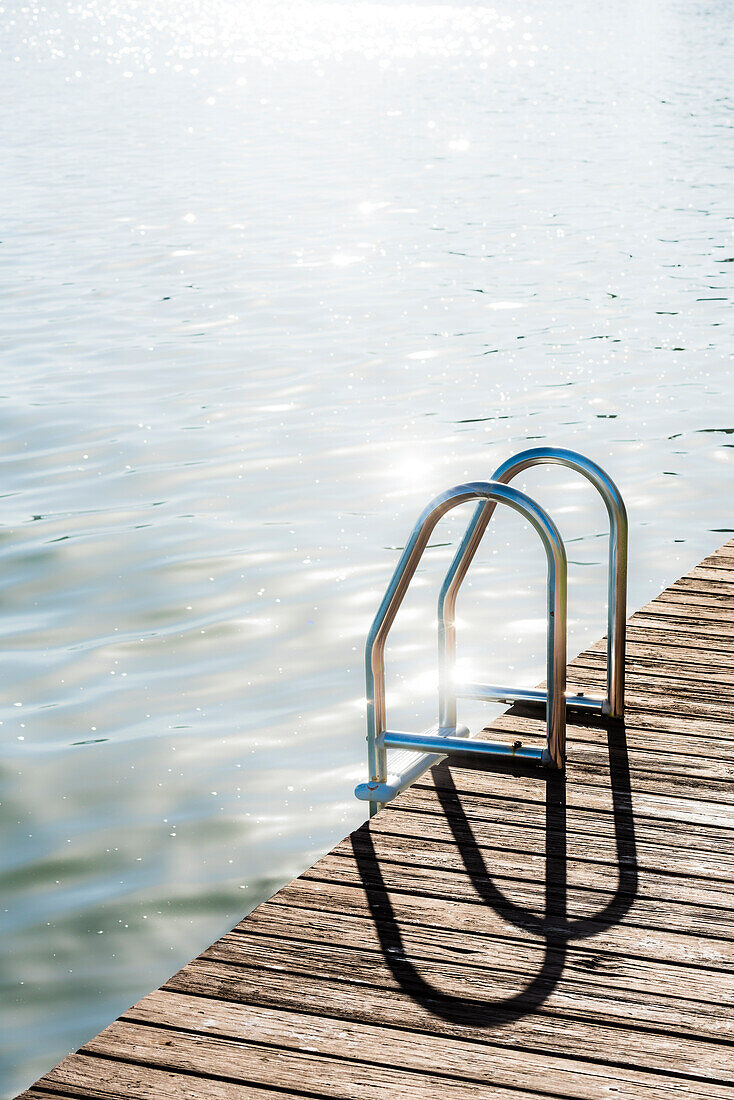 A bathing ladder with wood jetty against the light, Fort Myers Beach, Florida, USA