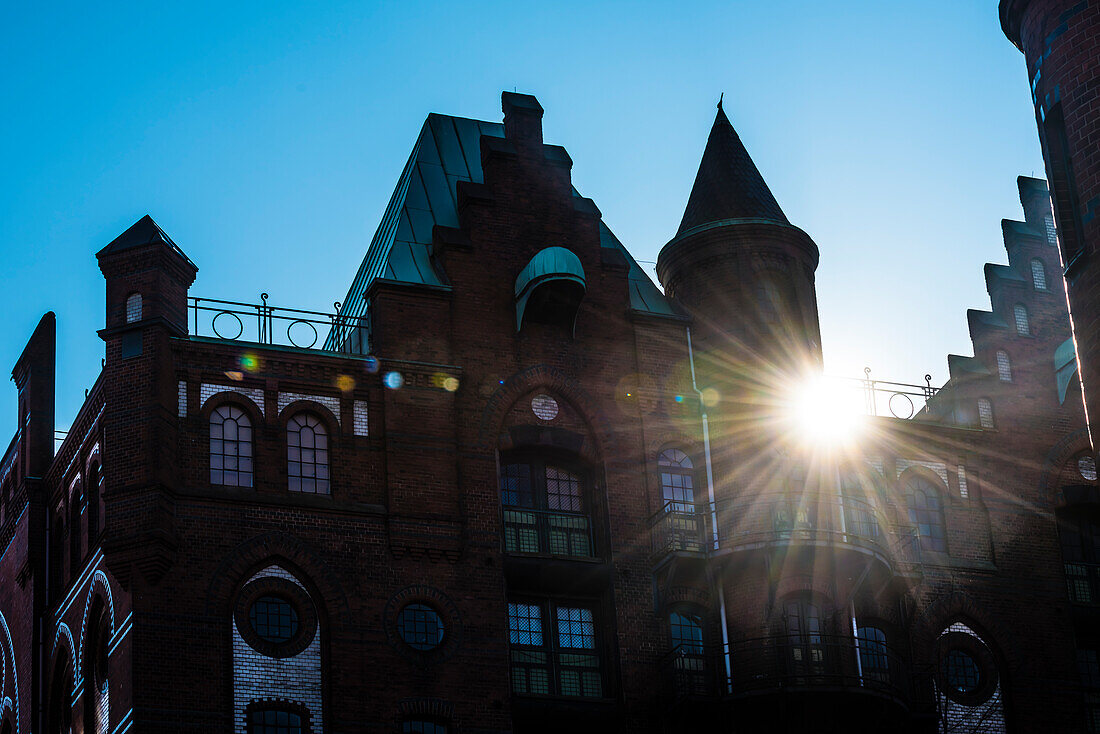 A historic office building in the historical storehouse district against the light, Hamburg, Germany