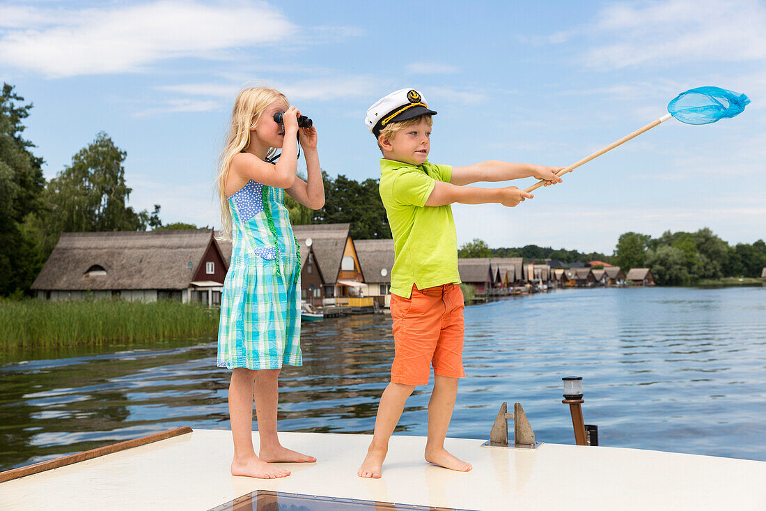 Girl and boy on boat, binocular, captain, children, houseboat tour, Lake Mirower See, Kuhnle-Tours, Mecklenburg lakes, Mecklenburg lake district, MR, Mirow, Mecklenburg-West Pomerania, Germany, Europe