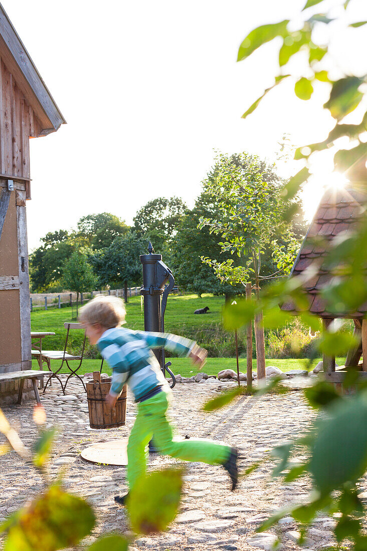 Holiday in the countryside, farm, farm house Bauernkate, garden, boy at the fountain, childhood, MR, Biosphere Reserve Schaalsee, Mecklenburg lake district, Klein Thurow, Mecklenburg-West Pomerania, Germany, Europe
