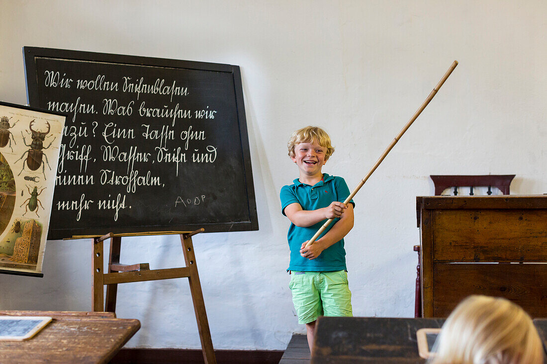 Little boy with stick, blackboard, enrollment into school, outdoor museum Mueß, provincial capital, Mecklenburg lakes, MR, Schwerin, Mecklenburg-West Pomerania, Germany, Europe