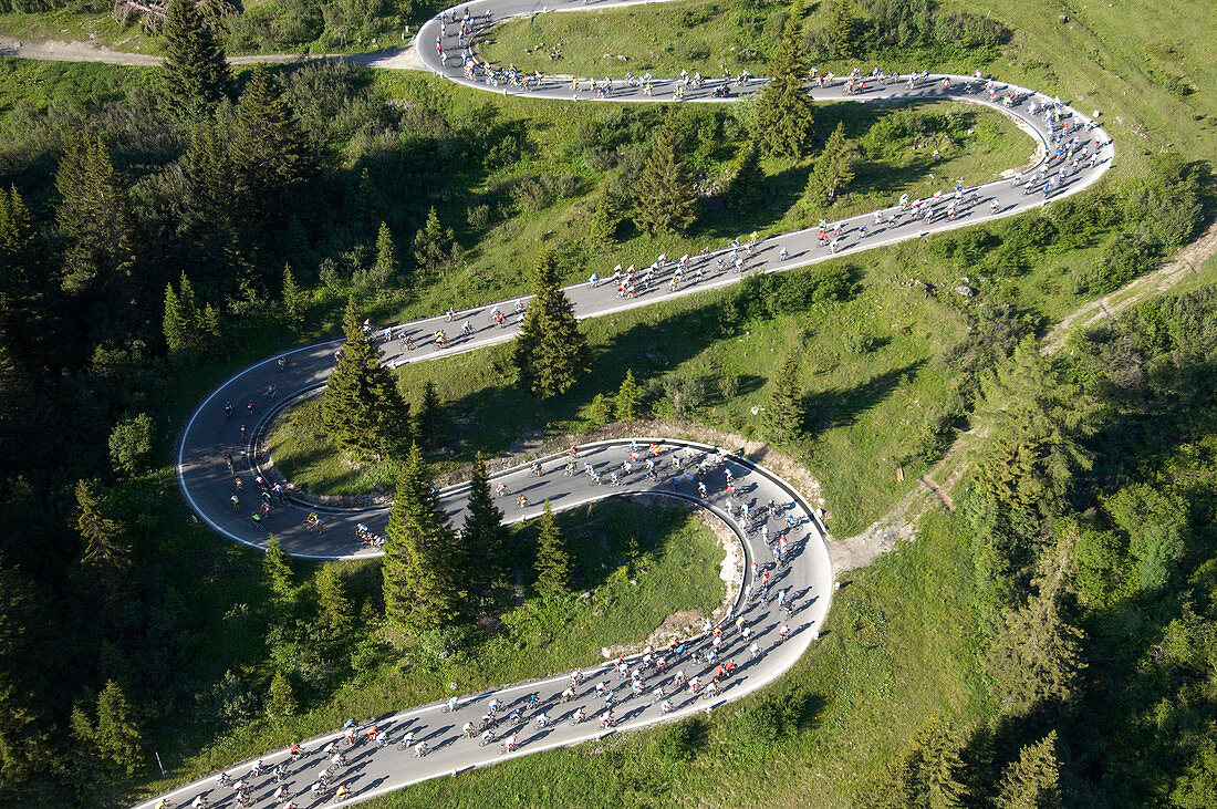 Aerial view of the road up to Passo Pordoi (2239 m), the second pass of the Maratona dles Dolomites bikerace. The race is held once a year in July with up to 8500 cyclists competing, from amateurs to professionals. Dolomites, Italy.