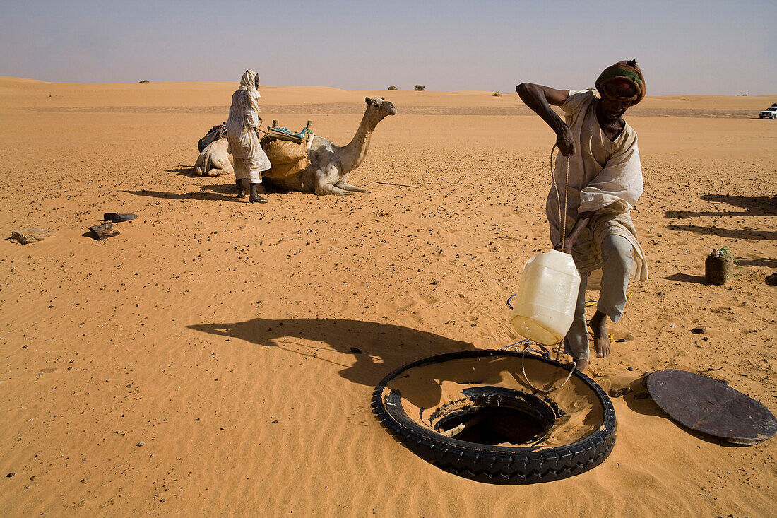 Water from a salty water well in Bresi in the Sahara Desert, Sudan is still usable for cooking for the camel caravan.