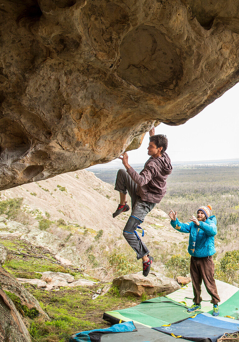 male climber bouldering in The Grampians of Victoria, Australia