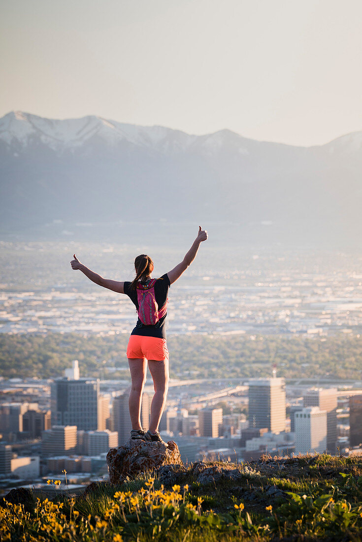 Rear View Of Woman Exploring Salt Lake City From A Field Of Wildflowers