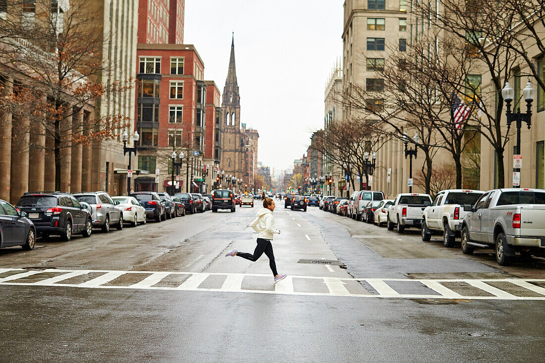 Female Athlete Jogging On Street Of Boston City