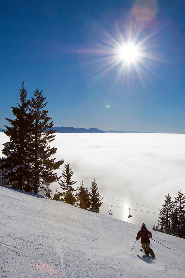 A Lone Male Skier Makes His Way Down A Run At Whitefish Mountain Resort