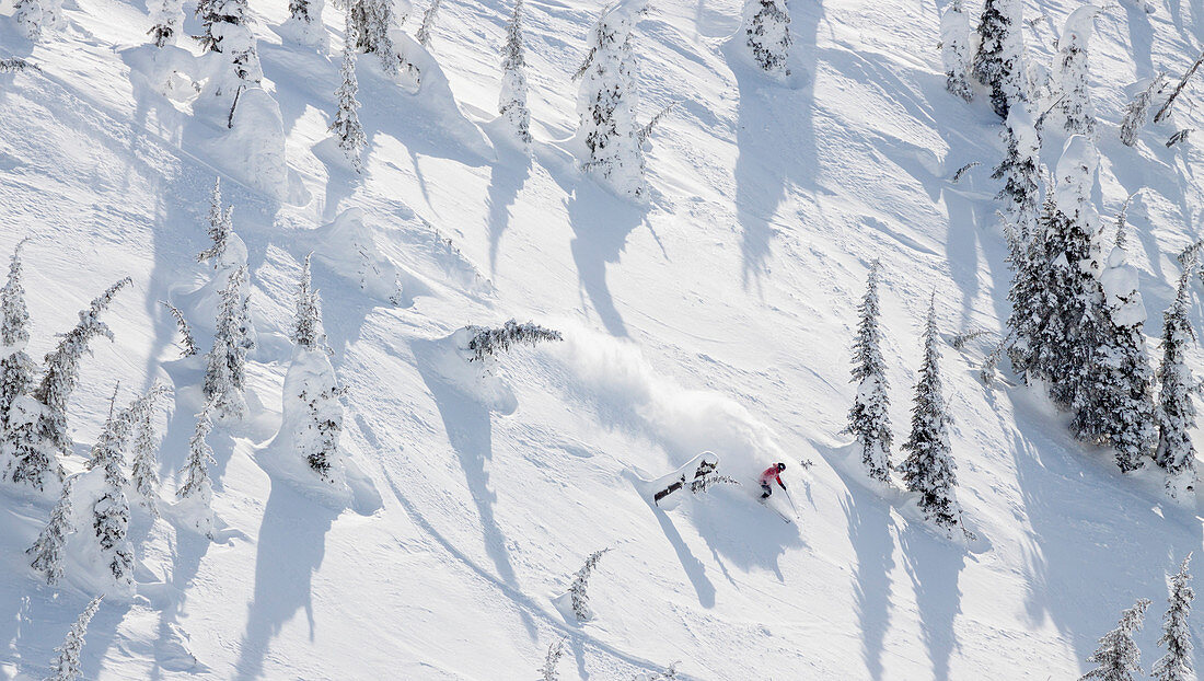 Male Skier Makes A Powder Turn At Whitefish Mountain Resort In Whitefish, Montana, Usa