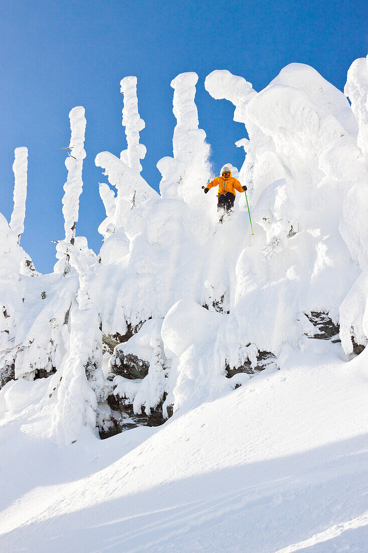 A Male Skier Airs A Cliff At Whitefish Mountain Resort In Whitefish, Montana