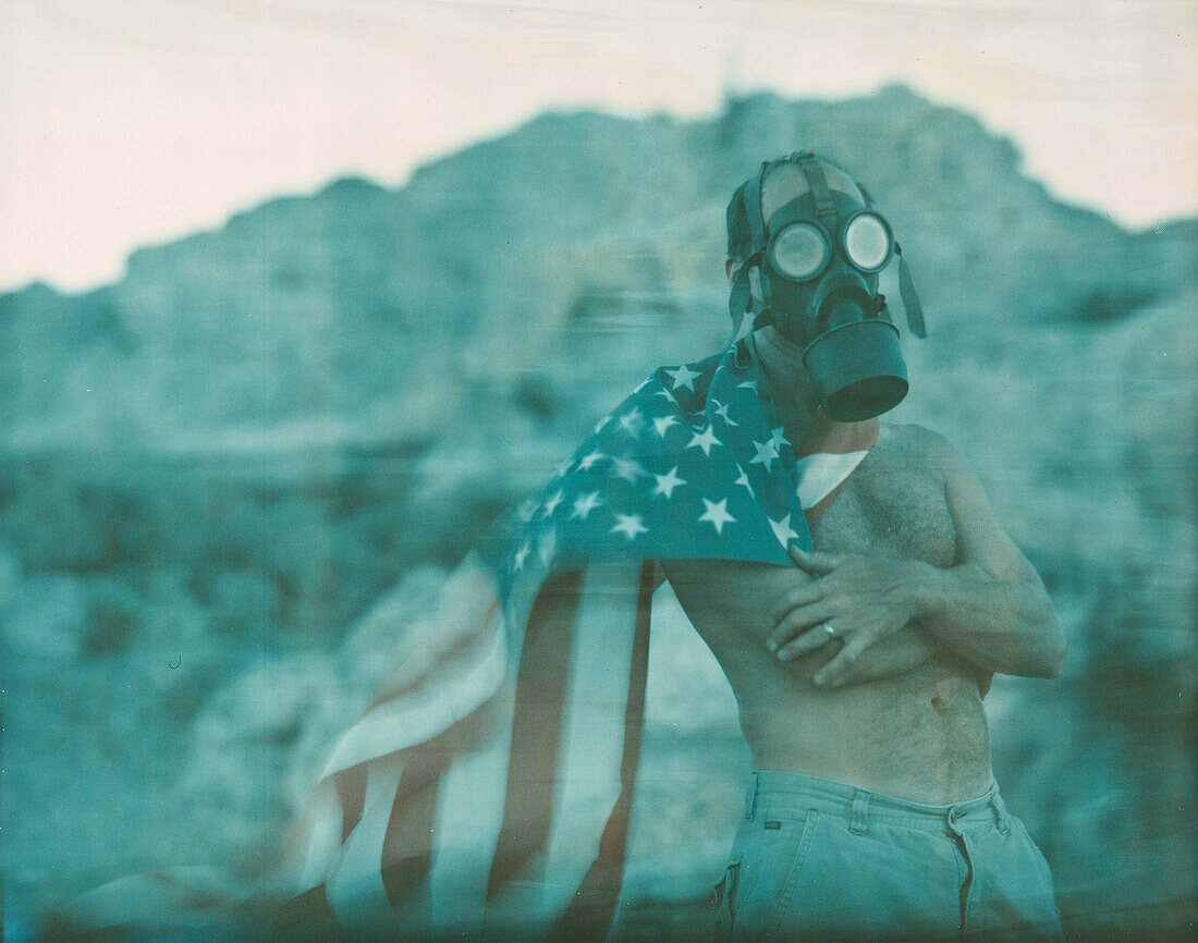Portrait Of Man Wearing Gas Mask With American Flag