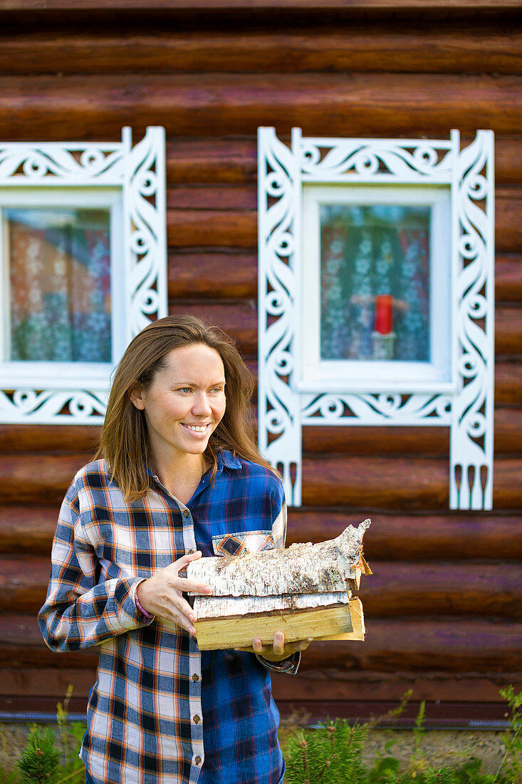 Smiling Woman Holding Firewood