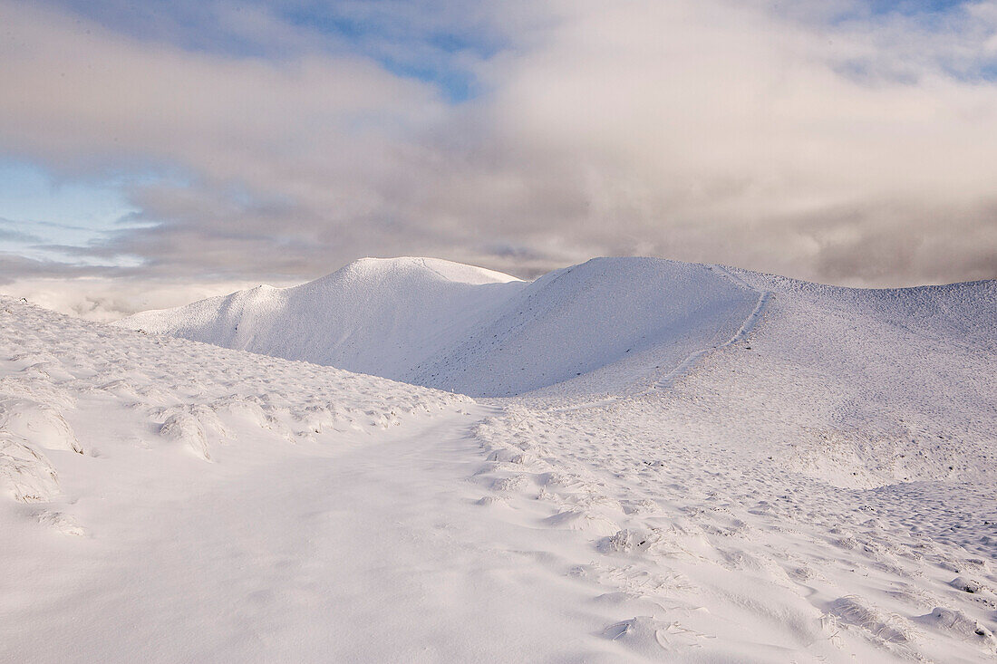A Snow Covered Trail Leads Along A Ridge To The Summit of Isthmus Peak, New Zealand