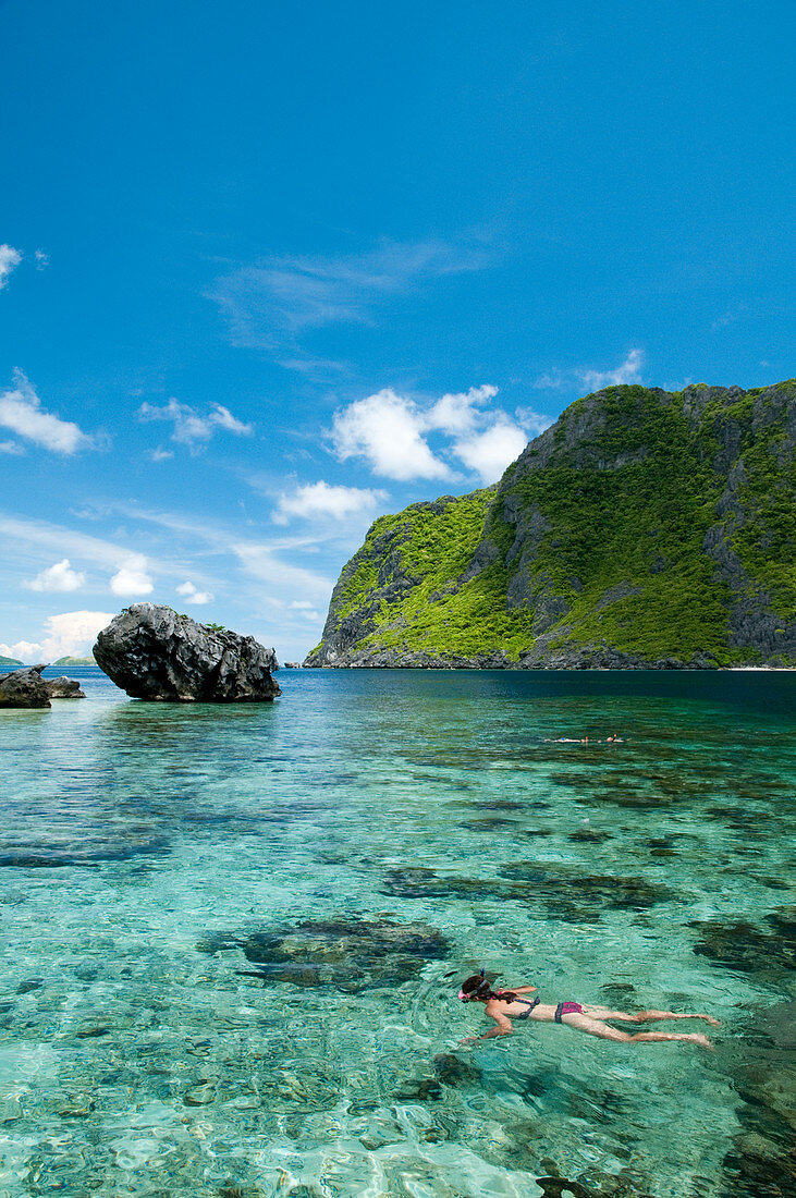 View Of Snorkeler Exploring The Tropical Reefs Of El Nido In The Philippines