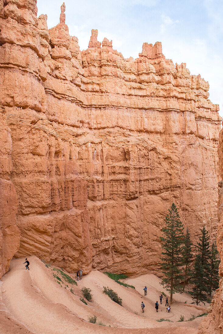 People Walk A Winding Trail In Bryce Canyon National Park