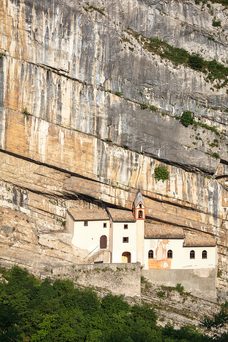 A view of Eremo di San Colombano, a monastery in Trambileno, Province of Trento, Italy, notable for its location in the side of a mountain