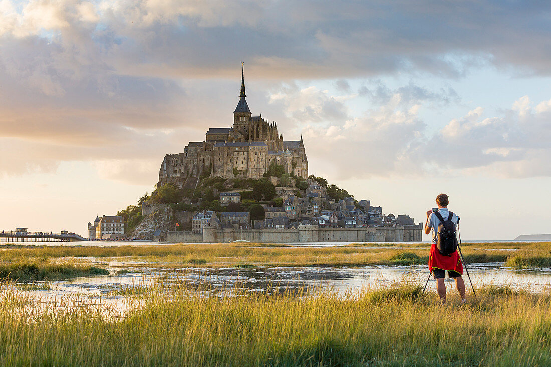 Man taking pictures at sunset,  Mont-Saint-Michel, Normandy, France