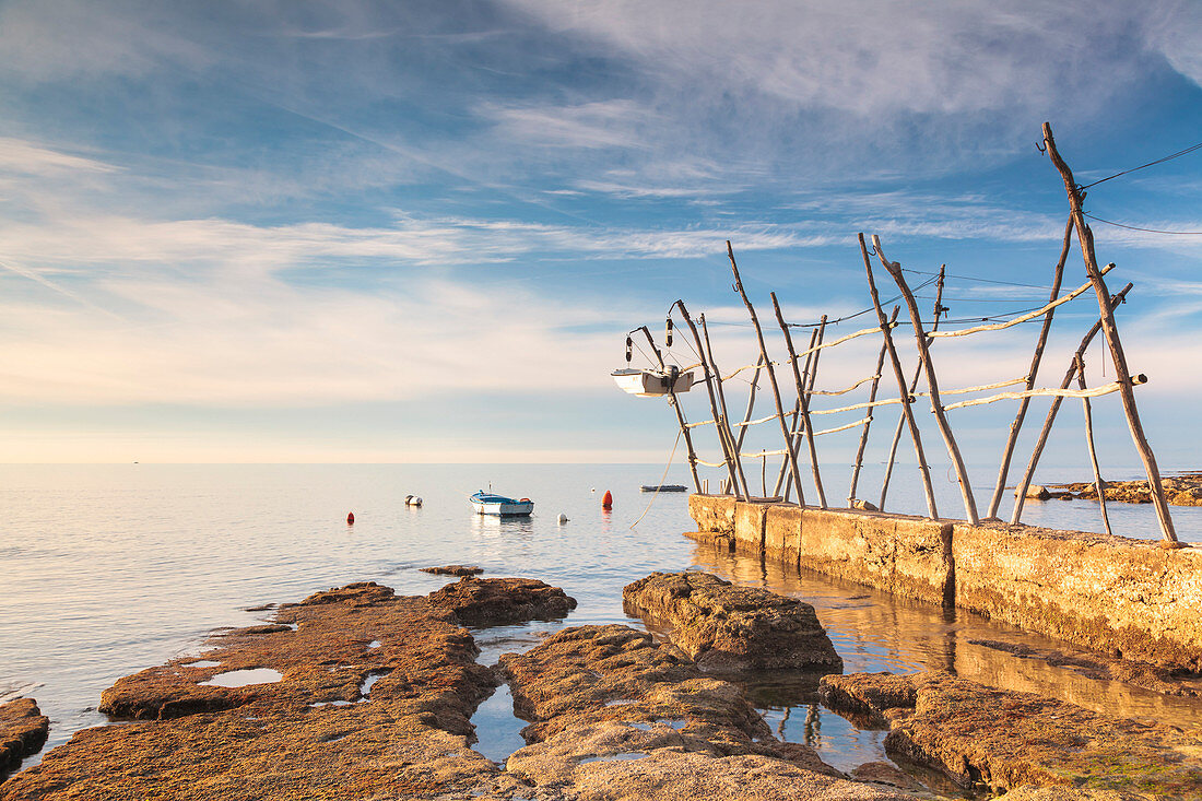 Europe, Croatia, Istria, Adriatic coast, Umag, village Savudrija,  Hanging fishing boat from traditional wooden cranes